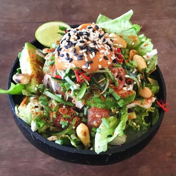 A poke-style bowl with sesame-crusted tuna and greens