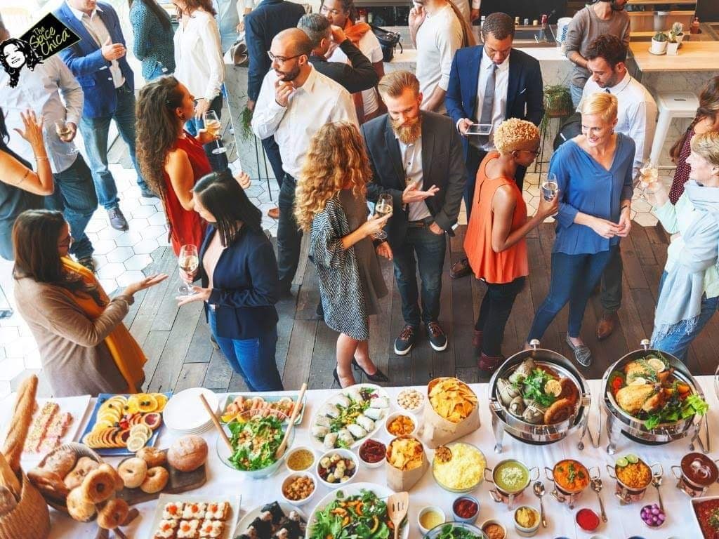 Guests around a grazing table of canapés at a private event