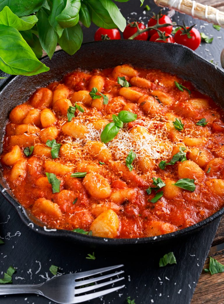 Homemade Italian Gnocchi with marinara sauce, cheese in iron pan - The ...